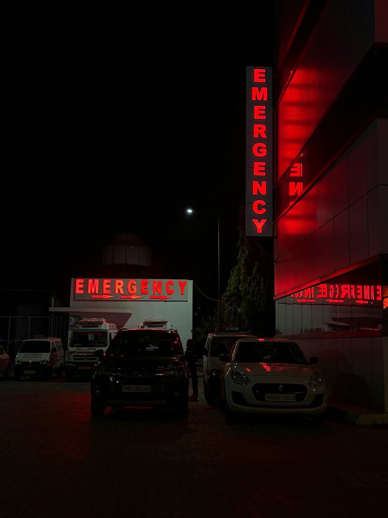 Emergency entrance at a hospital in Sahibzada Ajit Singh Nagar, India, at night.